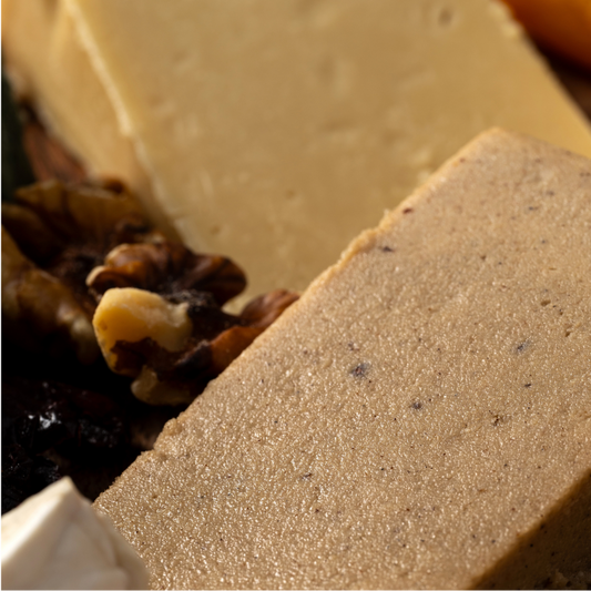 Close-up of a block of cheese with nuts and chocolate